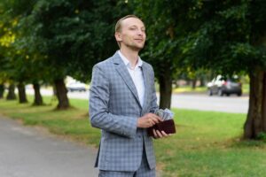 A businessman is counting money in his wallet.