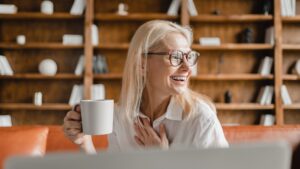 CEO leader freelancer working on laptop on distance online, drinking, watching webinars from home