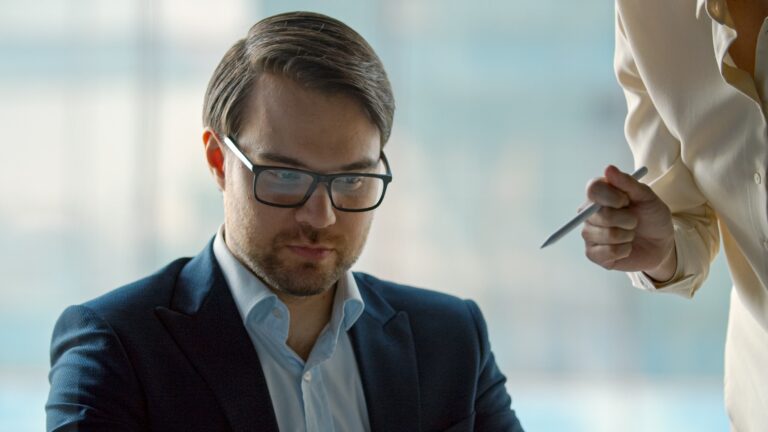 A corporate leader listening to a business finance team in a crisis. Mature leader works