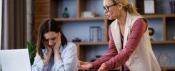 Angry female boss scolding scared office worker. Demanding manager leader is annoyed at laziness and