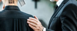 cropped view of man touching woman on funeral