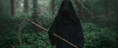 Death in a black hoodie with a scythe in forest