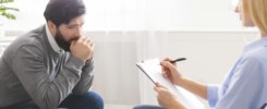 Depressed man getting psychological treatment at office