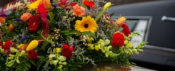 Funeral Casket and flowers next to hearse