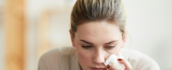 Grief-stricken woman wiping tears