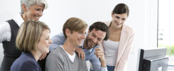 Happy business team at desk in office