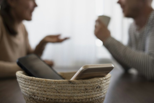 People on meeting without their phones. Digital detox, basket