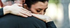 selective focus of woman hugging senior man