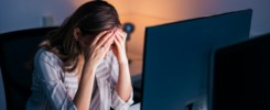 Stressed out woman working late in an office