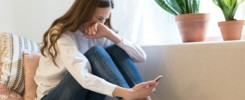 Upset woman cry read text message on smartphone suffer from breakup with boyfriend in tears on couch